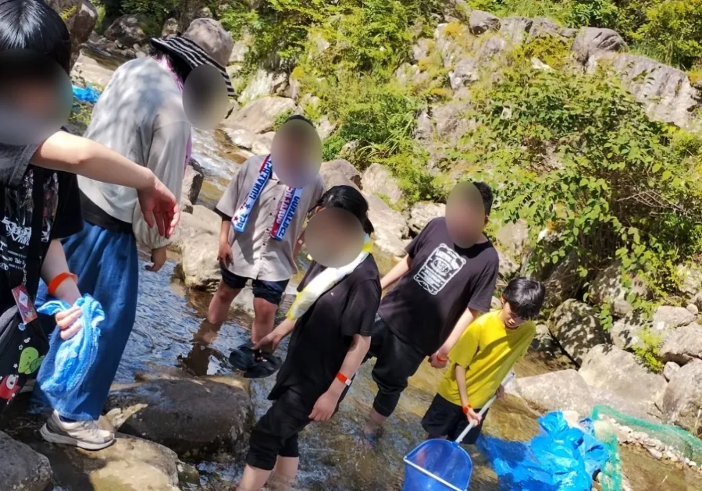 こどもたちが川で遊んでいる